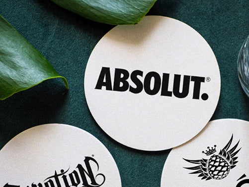 After — same logo with the background removed, wood grain visible through it